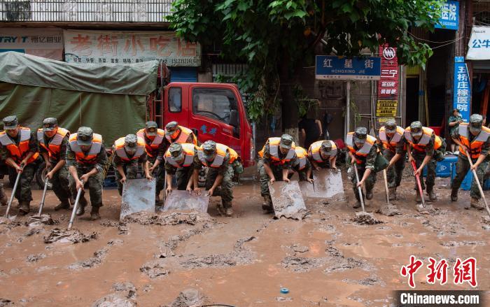 7月4日，萬(wàn)州區(qū)五橋街道，武警官兵清理街道上的淤泥?！∪矫宪?攝