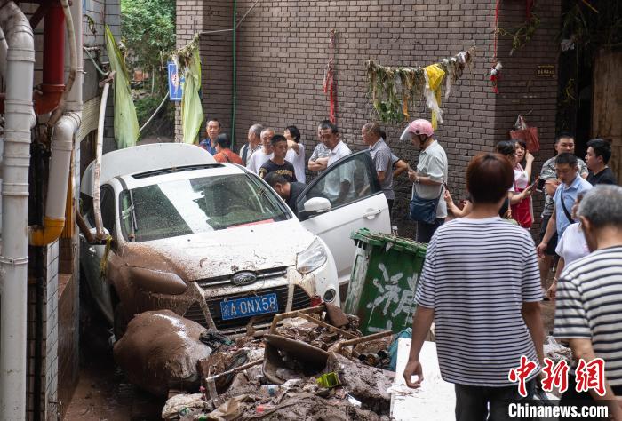 7月4日，萬(wàn)州區(qū)五橋街道，居民救援受困的私家車?！∪矫宪?攝