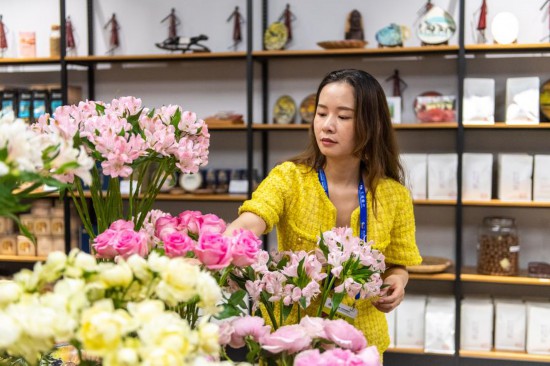 2023年7月1日，在位于湖南省長沙市的湖南高橋大市場，中非經(jīng)貿(mào)博覽會常設(shè)展館展區(qū)肯尼亞館工作人員在整理產(chǎn)自非洲的鮮花。新華社記者 陳思汗 攝