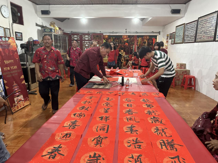 茍皓東為華人朋友現(xiàn)場(chǎng)寫(xiě)春聯(lián)送福字。巴陵康孔子學(xué)院供圖