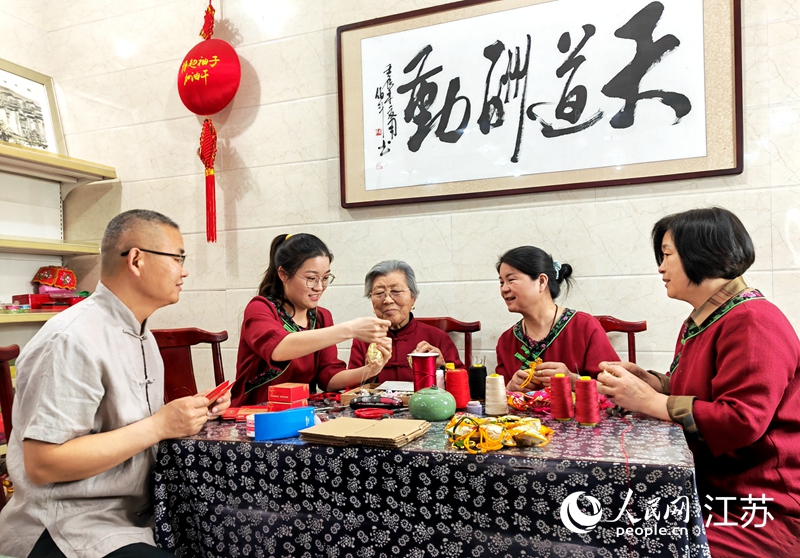 王秀英老人指導(dǎo)孫女制作香包。人民網(wǎng) 閆峰攝