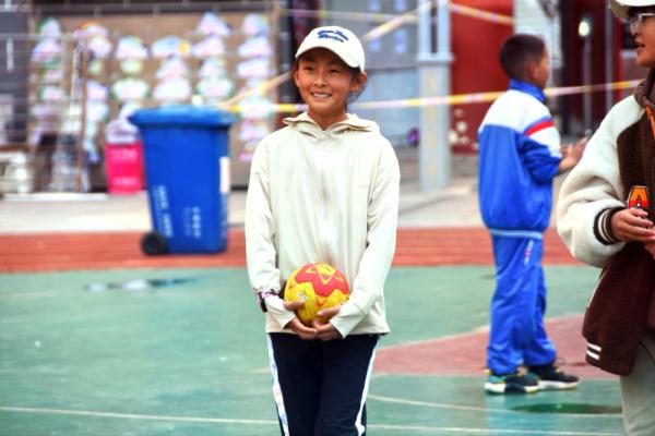 在高原上教孩子們打手球，“慢慢兒來，甭著急！”