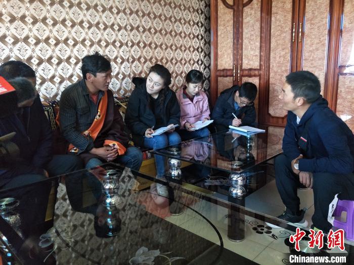 圖為調(diào)查組工作人員正在入戶(hù)調(diào)查?！∑钤鲚?攝