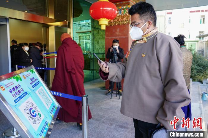 圖為政協(xié)委員掃場(chǎng)所碼進(jìn)入會(huì)場(chǎng)?！〗w波 攝